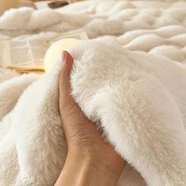 A hand pressing into Bubble Cuddle’s soft faux-fur pile